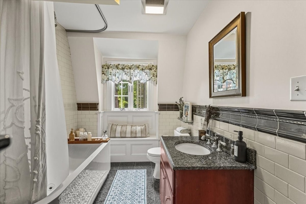 155 Mt Vernon Street Dedham, MA 02026 - Photo 40 of 50 a bathroom with a granite countertop tub a sink and a window