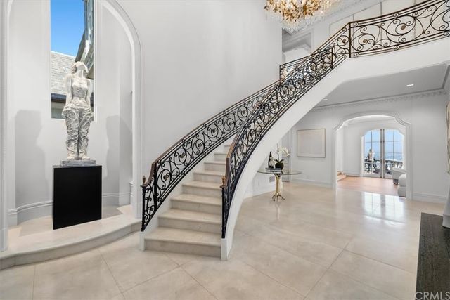 a living room with furniture a fireplace and a chandelier