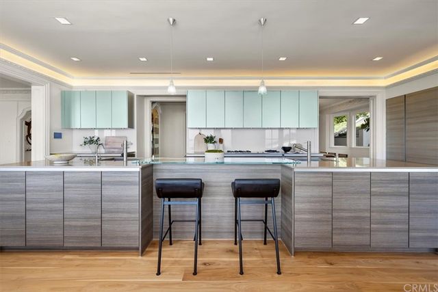 a view of a dining room with furniture a chandelier and window