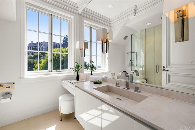 a spacious bedroom with a bed couch and a large window