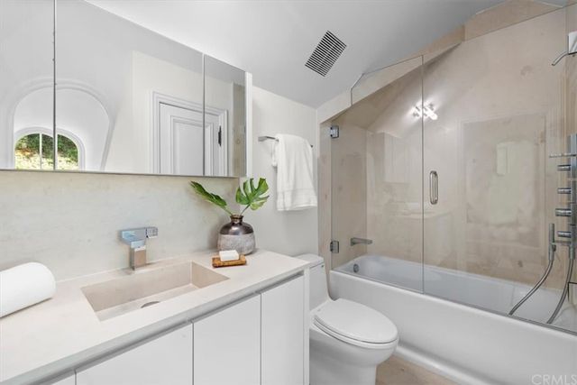 a kitchen with stainless steel appliances granite countertop a sink and a stove top oven