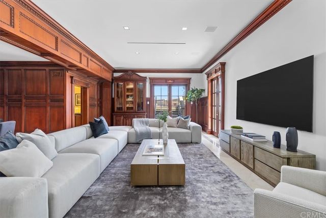 a living room with furniture a table and a large window