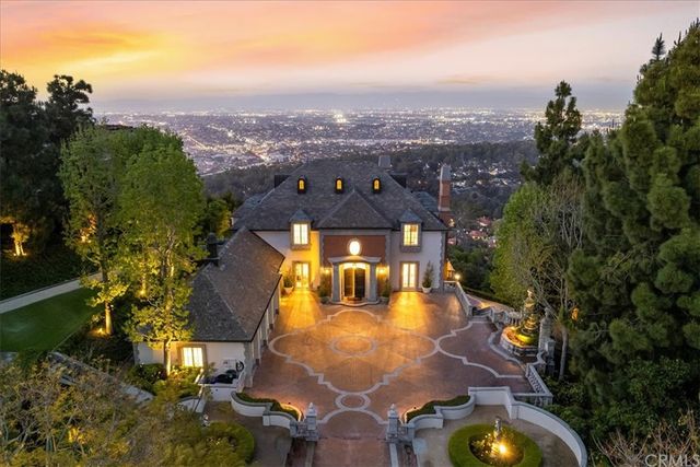 an aerial view of a house with swimming pool and big yard