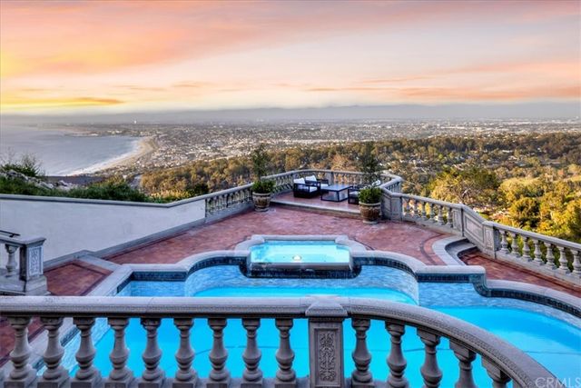 a view of a balcony with wooden chairs