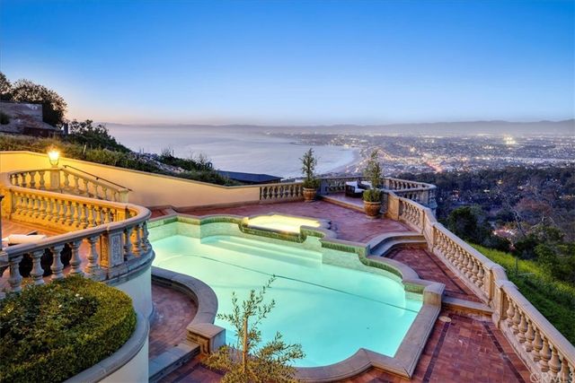 a view of a patio with table and chairs and potted plants with wooden fence