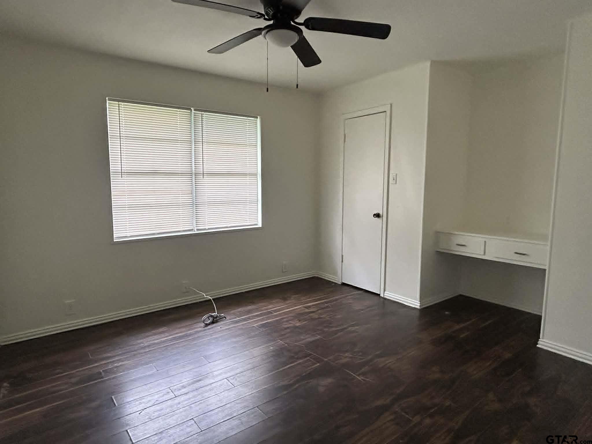 15987 State Highway 155 Tyler, TX 75703 - Photo 11 of 11 a view of an empty room with a window and wooden floor