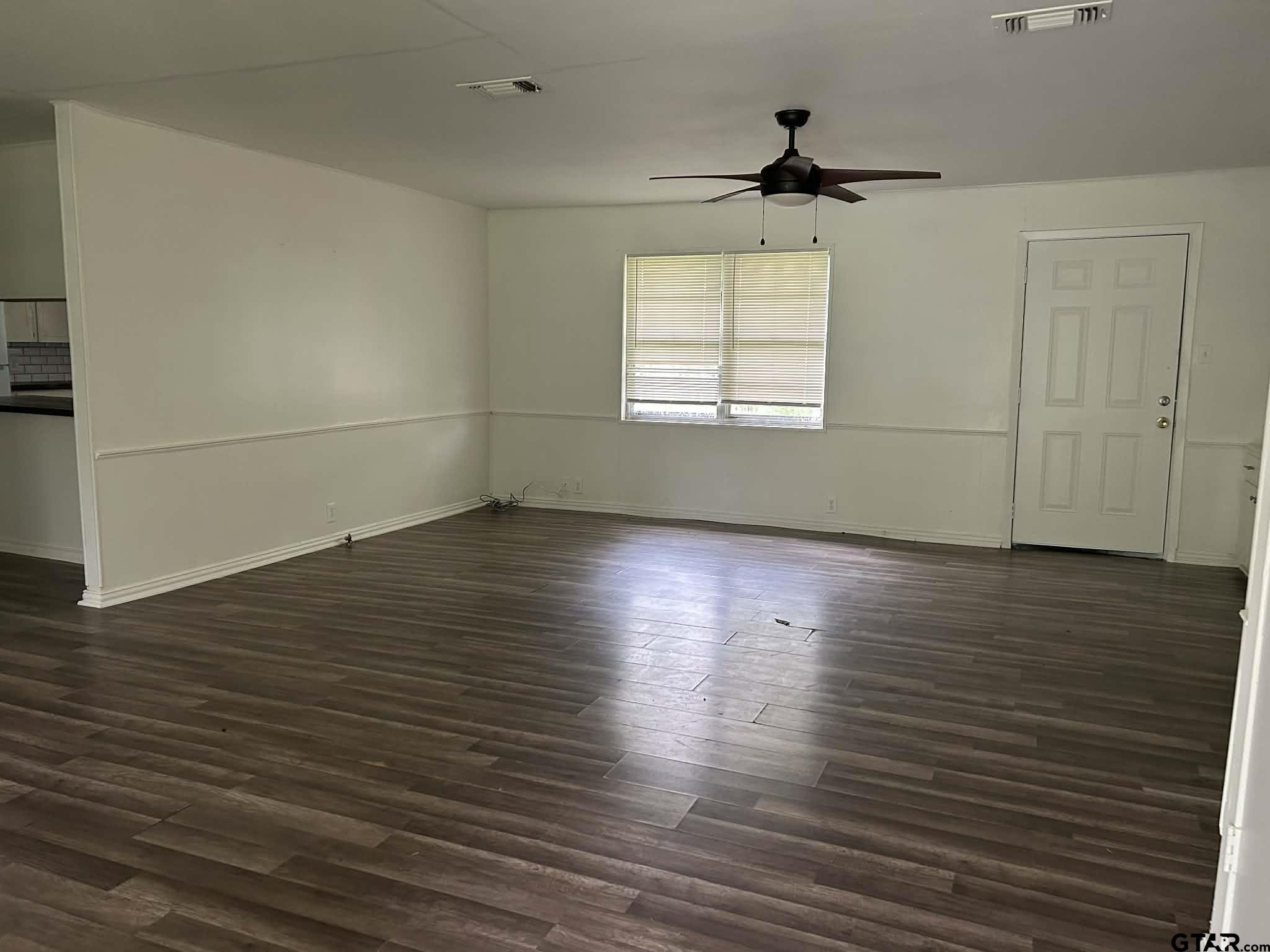 15987 State Highway 155 Tyler, TX 75703 - Photo 3 of 11 an empty room with wooden floor and windows