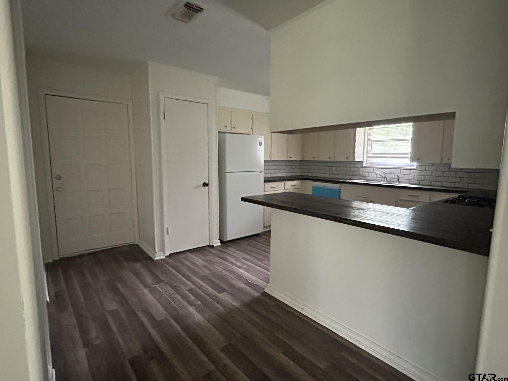 15987 State Highway 155 Tyler, TX 75703 - Photo 4 of 11 a kitchen with granite countertop a sink and a stove top oven