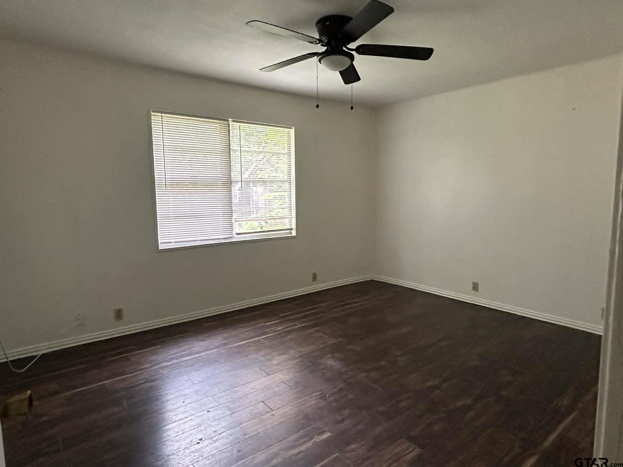 15987 State Highway 155 Tyler, TX 75703 - Photo 7 of 11 a view of an empty room with wooden floor and a window