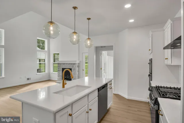 a kitchen with stainless steel appliances a stove sink and refrigerator
