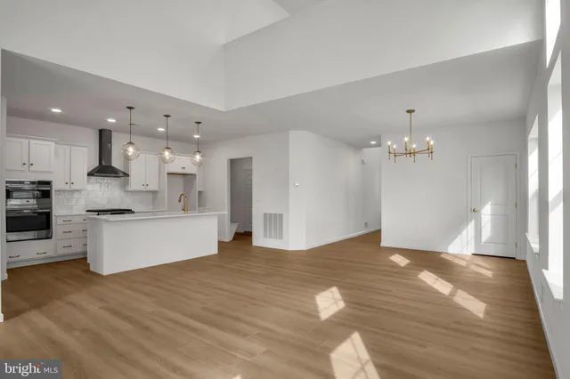a living room with stainless steel appliances kitchen island granite countertop furniture
