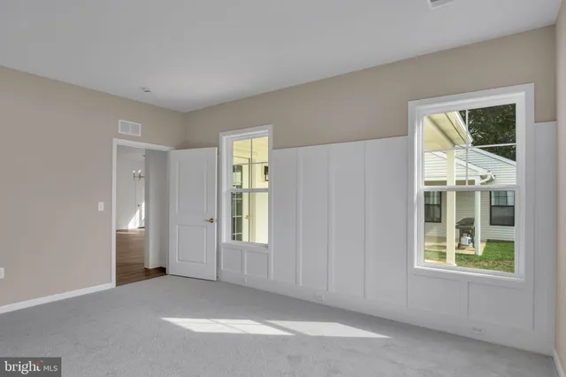 an empty room with windows and closet