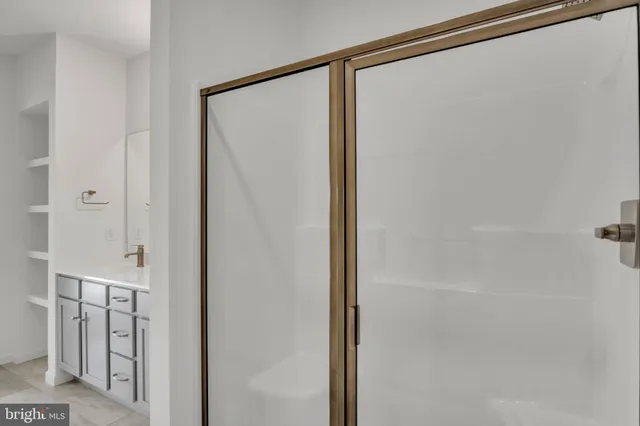 a bathroom with a glass shower door