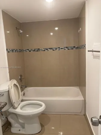 a bathroom with a toilet a sink and bathtub