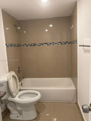 a bathroom with a toilet a sink and bathtub