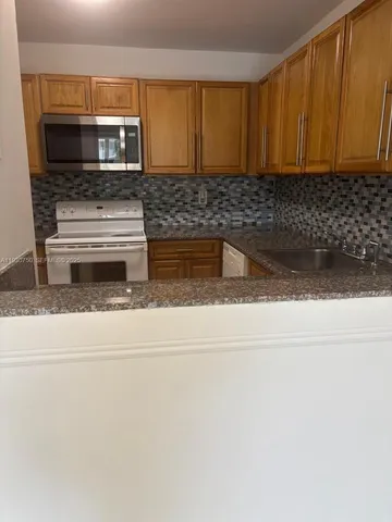 a kitchen with a stove and a microwave