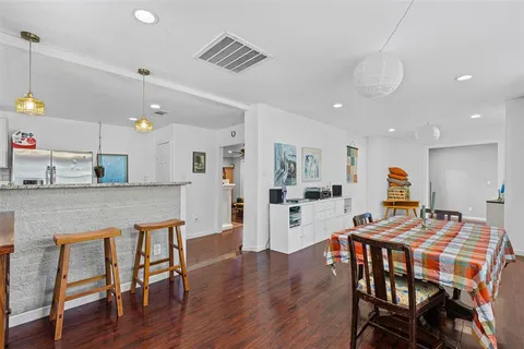 a dining room with furniture and wooden floor