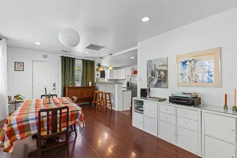 a bedroom with furniture and wooden floor
