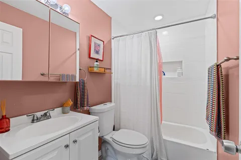 a bathroom with a sink toilet and shower