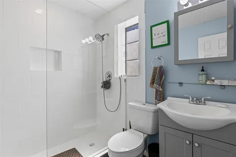 a bathroom with a sink toilet and shower