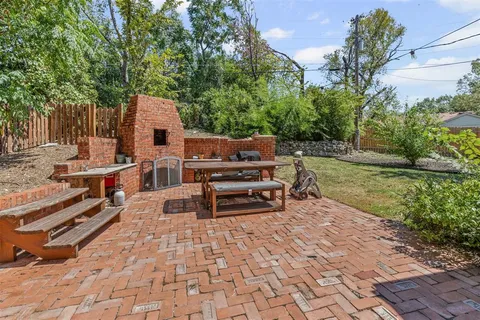 a backyard of a house with yard and outdoor seating