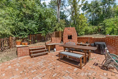 a view of a chairs and tables in the back yard of the house