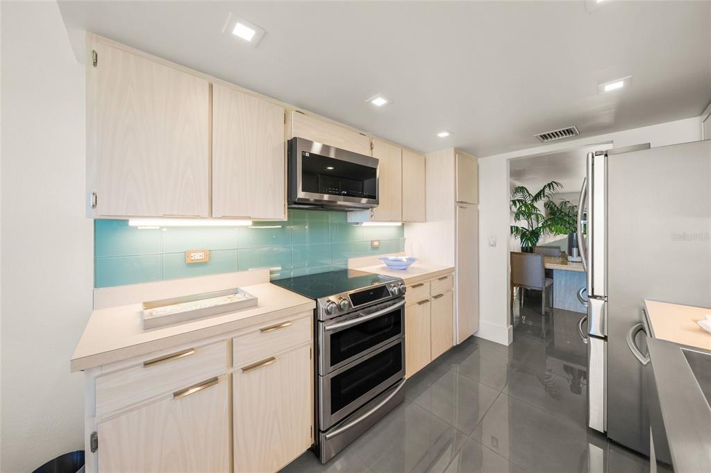 420 Beach Road, Unit 606 Sarasota, FL 34242 - Photo 19 of 83 a kitchen with a sink cabinets and wooden floor
