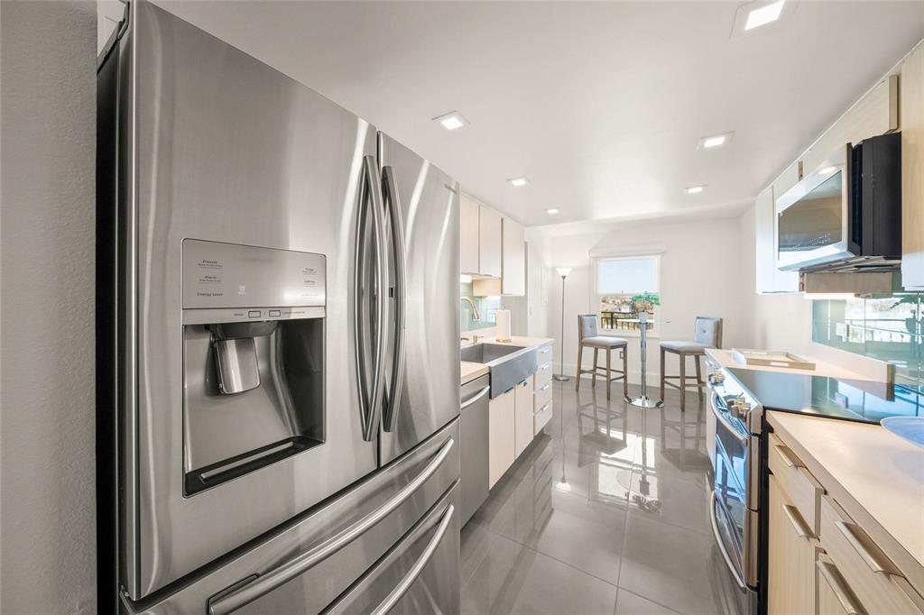 420 Beach Road, Unit 606 Sarasota, FL 34242 - Photo 20 of 83 a kitchen with stainless steel appliances granite countertop a refrigerator and a stove top oven