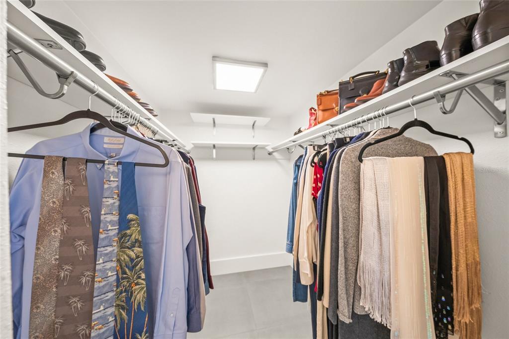 420 Beach Road, Unit 606 Sarasota, FL 34242 - Photo 28 of 83 a view of walk in closet with clothes and shoes