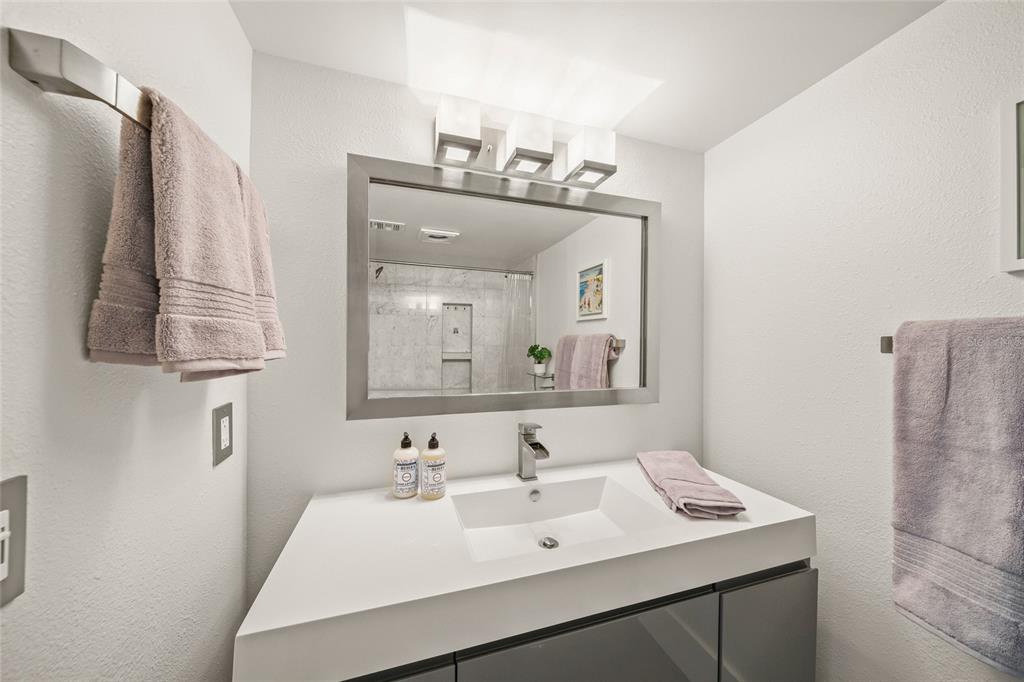 420 Beach Road, Unit 606 Sarasota, FL 34242 - Photo 31 of 83 a bathroom with a sink vanity and mirror