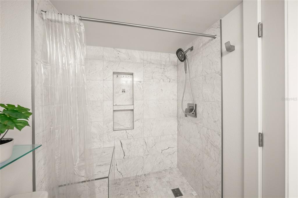 420 Beach Road, Unit 606 Sarasota, FL 34242 - Photo 32 of 83 a bathroom with a shower and a glass door