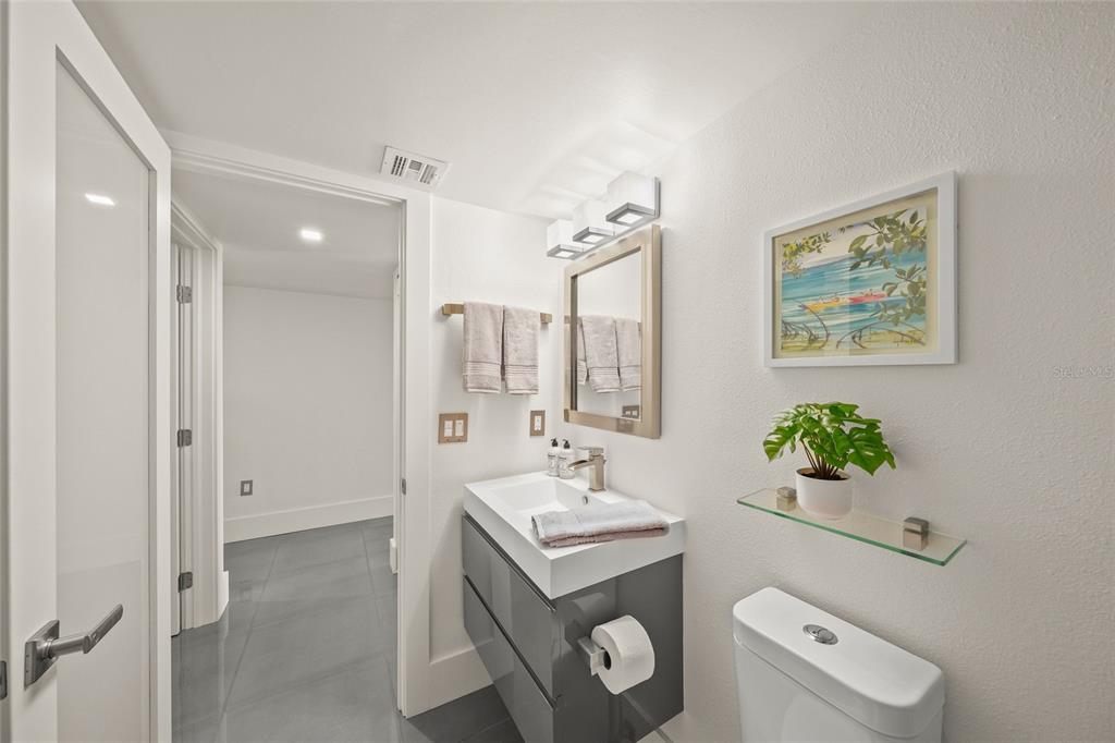 420 Beach Road, Unit 606 Sarasota, FL 34242 - Photo 38 of 83 a bathroom with a sink mirror vanity and toilet