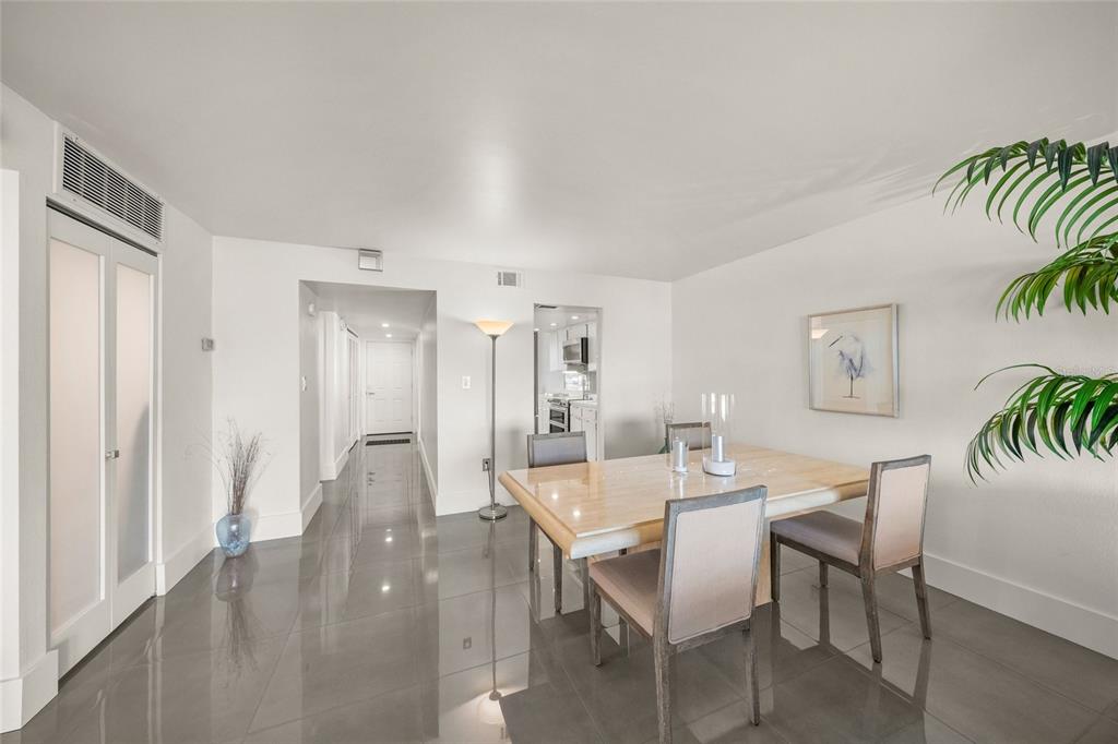 420 Beach Road, Unit 606 Sarasota, FL 34242 - Photo 39 of 83 a dining room with furniture and wooden floor