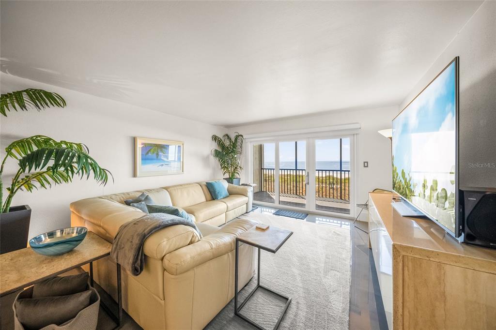 420 Beach Road, Unit 606 Sarasota, FL 34242 - Photo 7 of 83 a living room with furniture a large window and a flat screen tv