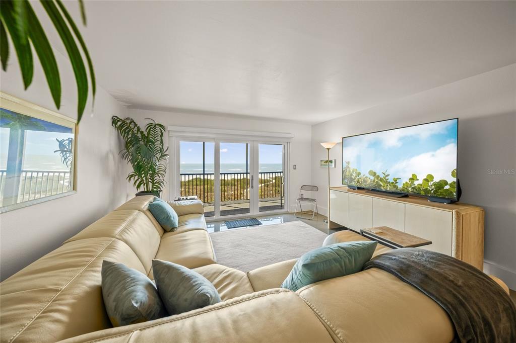 420 Beach Road, Unit 606 Sarasota, FL 34242 - Photo 9 of 83 a living room with couches a coffee table and a flat screen tv