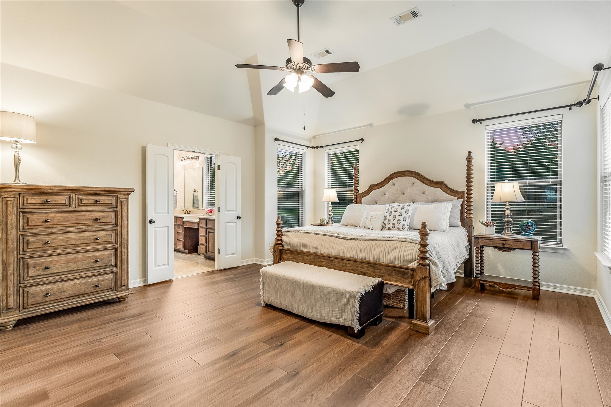 226 Galloway Lane Austin, TX 78737 - Photo 16 of 30 Bedroom featuring wood finished floors, a ceiling fan, vaulted ceiling, and connected bathroom