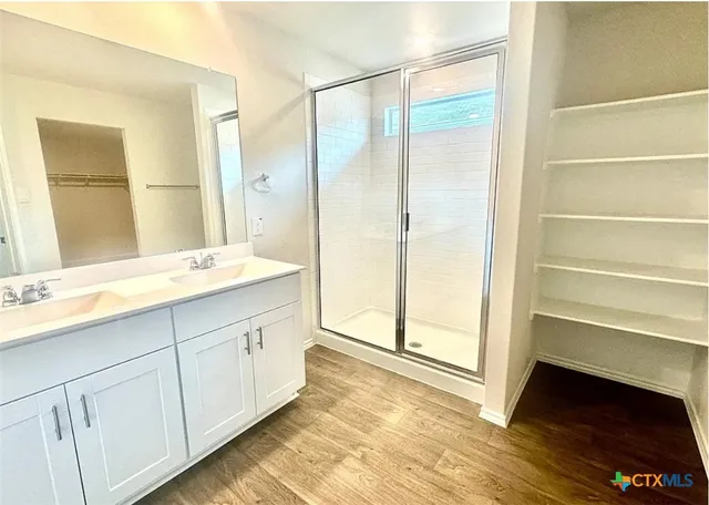 a view of walk in closet with empty racks
