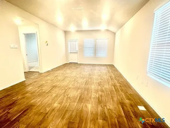 a kitchen with granite countertop a sink stove and cabinets