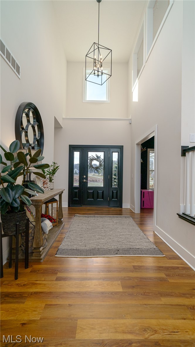 1849 Fixler Road Wadsworth, OH 44281 - Photo 18 of 39 Foyer entrance with a towering ceiling, a wealth of natural light, a notable chandelier, and dark hardwood / wood-style floors