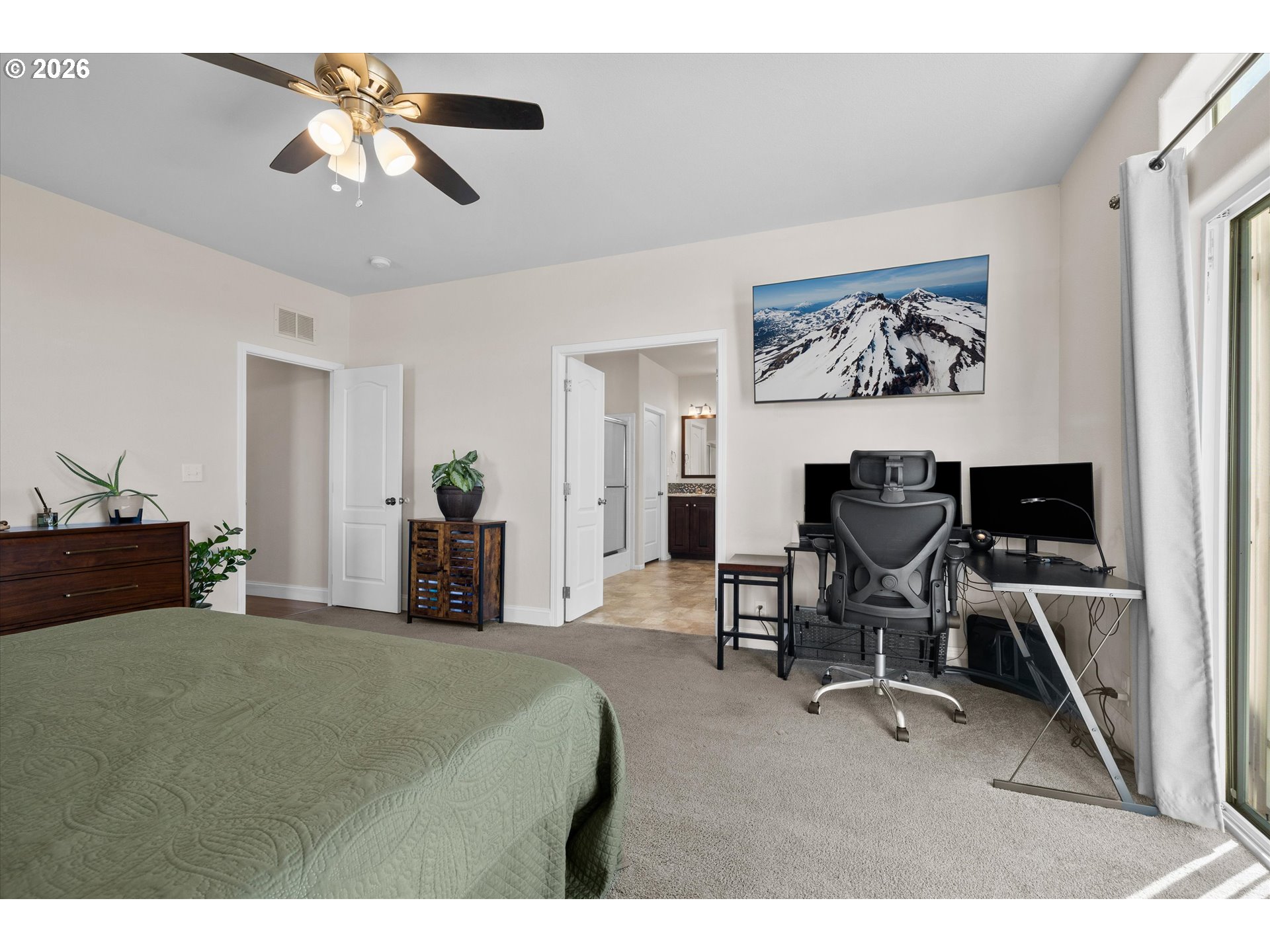 5172 Southeast Oswego Road Prineville, OR 97754 - Photo 28 of 48 a bedroom with a bed and a chandelier
