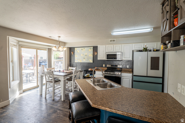 1443 West 250 North Springville, UT 84663 - Photo 10 of 23 Kitchen featuring a central island with a double basin sink and integrated breakfast bar