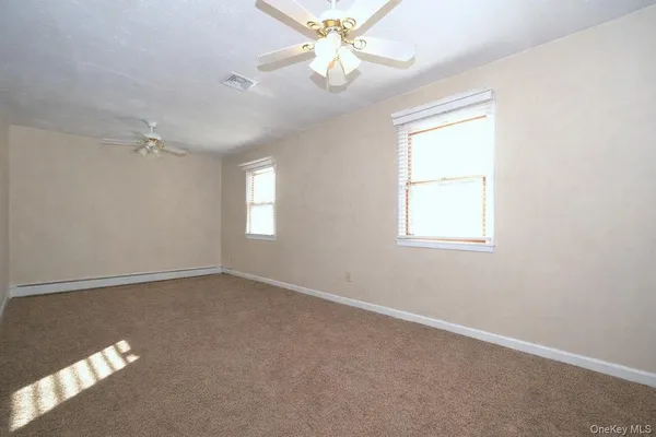 a living room with furniture a flat screen tv and a window