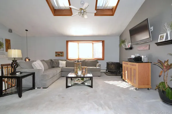 a view of a livingroom with furniture and a window