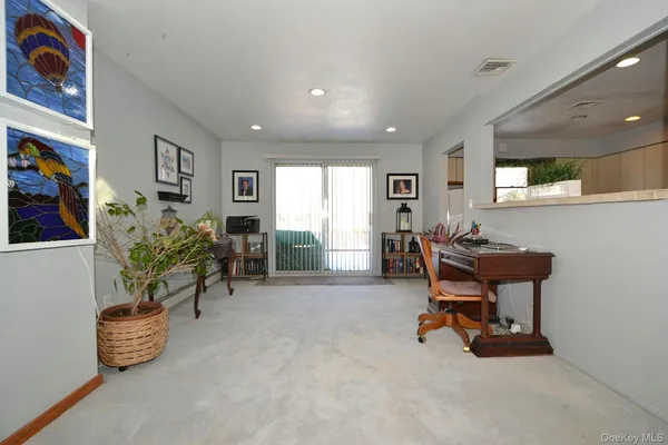 a spacious bedroom with a large bed and a chandelier