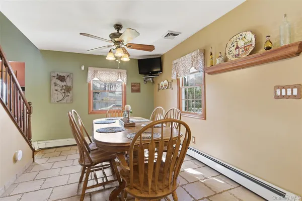 a view of a dining room with furniture and a chandelier