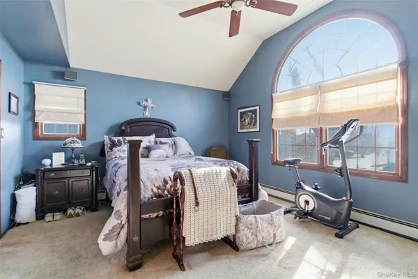 a bedroom with bed and windows