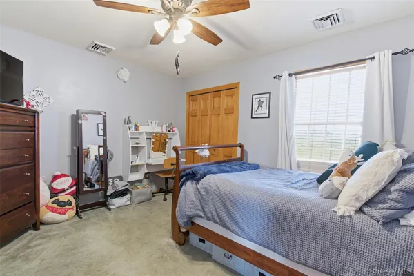 a bed room with a bed and a chair