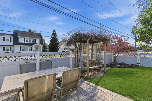 a view of a patio with table and chairs and potted plants