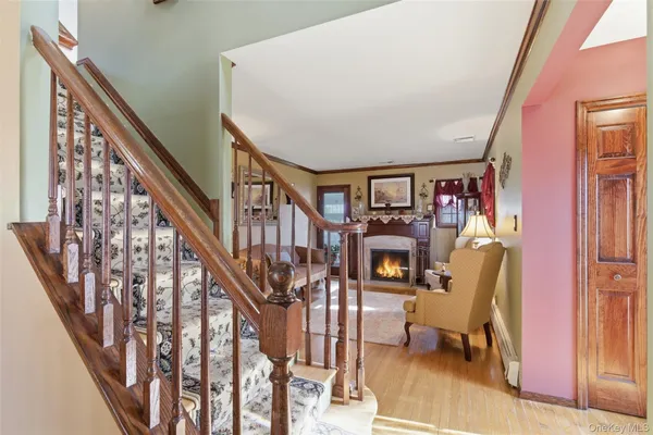 a view of entryway and hall with wooden floor