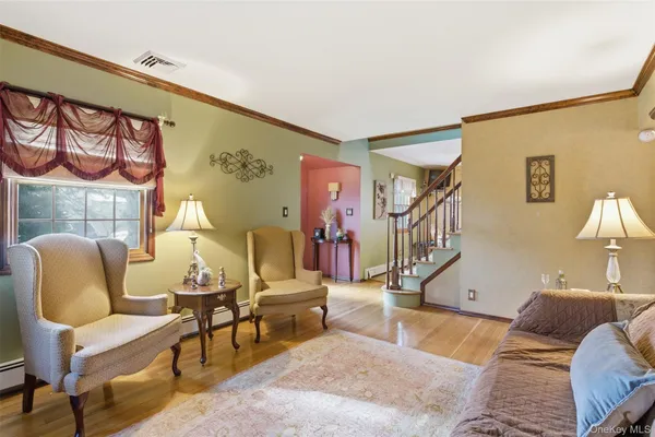 a living room with furniture and a painting